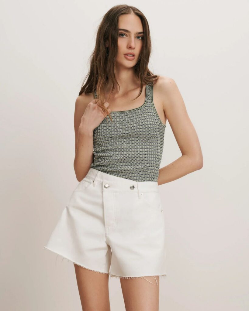 Striped tank top styled with high-waisted white shorts
