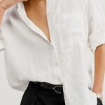 White linen button-down styled with black trousers