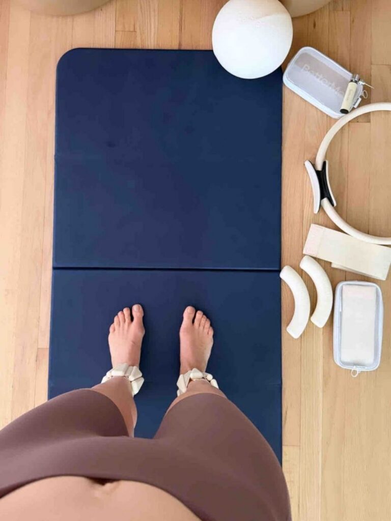Activewear outfit with yoga mat and white heels