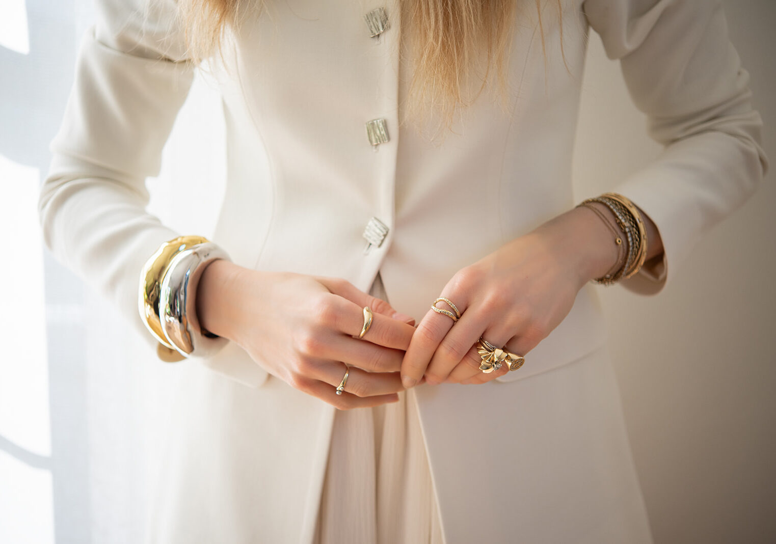 Personal stylist adjusting white blazer