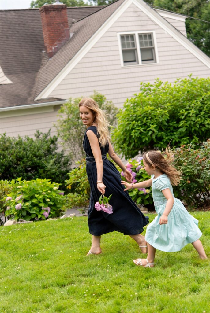 Liz Teich and daughter running in their background